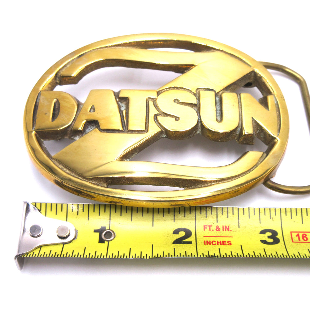 
                      
                        Vintage Datsun Solid Brass Belt Buckle 1978 NOS
                      
                    